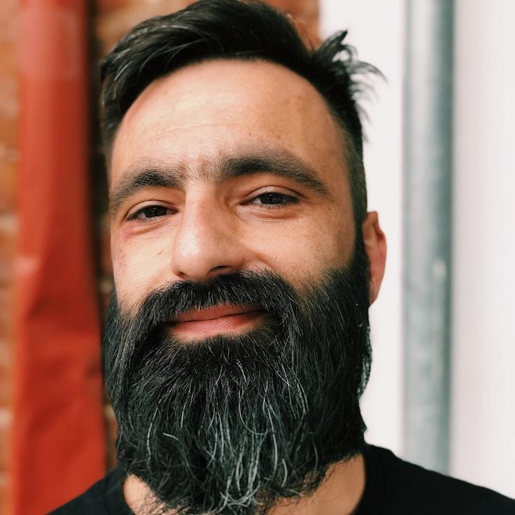 Aria Kapoor, Lead Design Curator at MossFieldCove, reviewing corporate floral arrangements